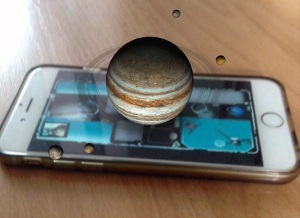 Picture of iSolarSytem App in action, with moons rotating around a planet