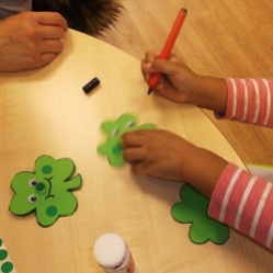 Making shamrock faces for St Patrick's Day 2017 at Kensal Library
